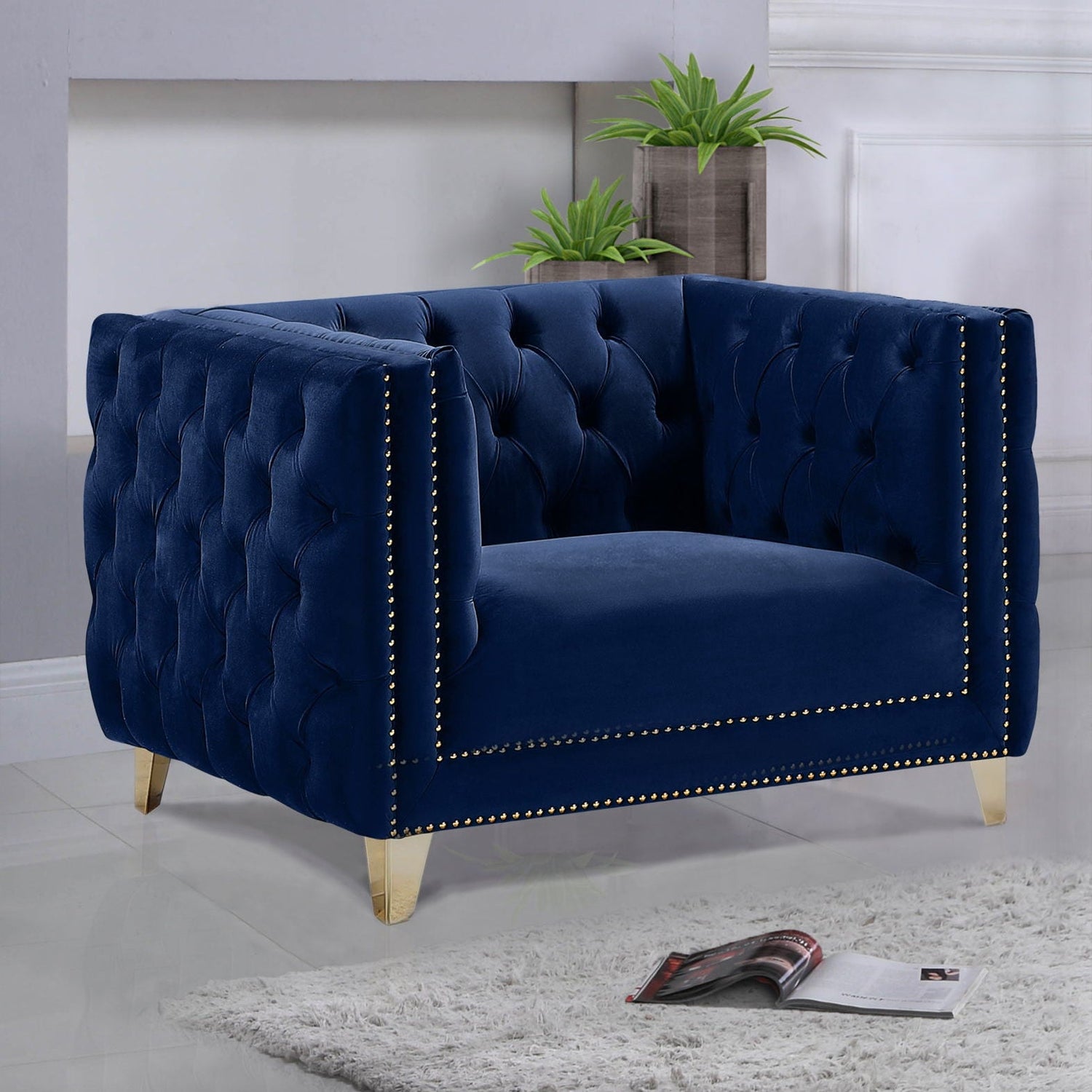 Navy blue tufted armchair in a room with decor elements.