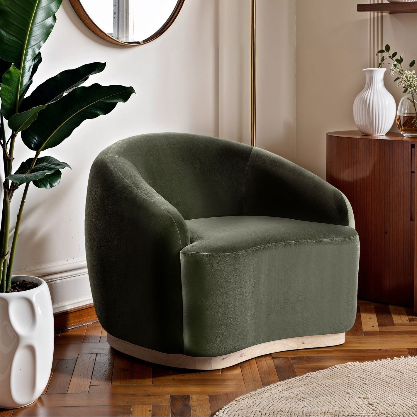 Modern living room with a green armchair, wooden cabinet, and decorative items.